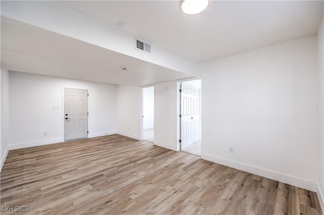 unfurnished room with light wood-type flooring