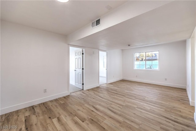 spare room featuring light hardwood / wood-style floors