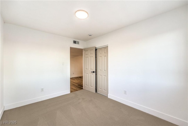 unfurnished bedroom with carpet and a closet