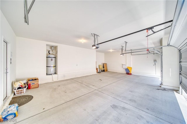 garage with a garage door opener and strapped water heater