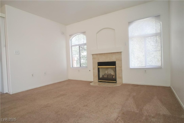 unfurnished living room featuring a fireplace and light colored carpet