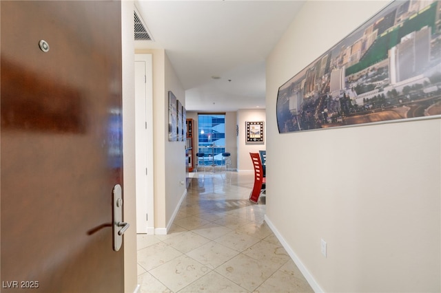 hall with light tile patterned floors