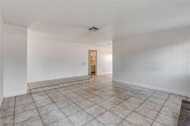 spare room featuring light tile patterned floors