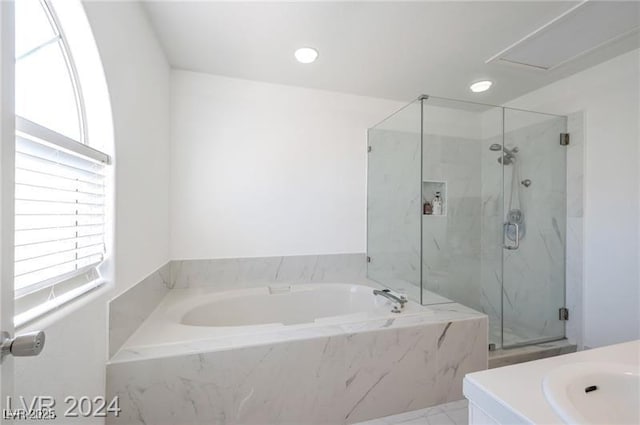 bathroom featuring separate shower and tub