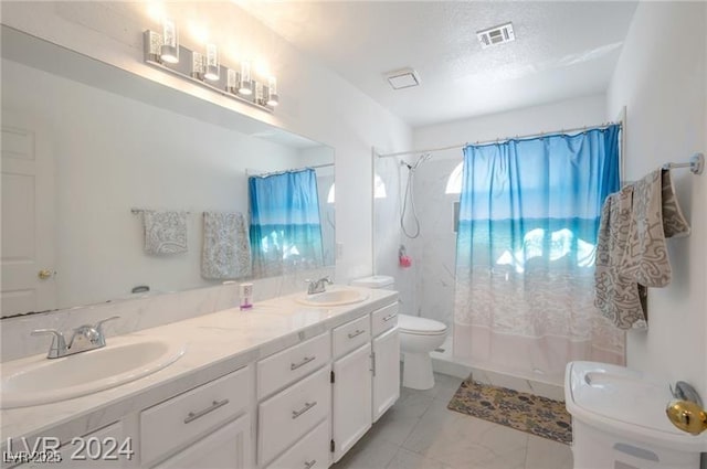 bathroom with a textured ceiling, toilet, vanity, and a shower with shower curtain