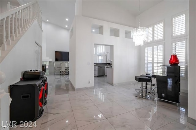 dining room featuring an inviting chandelier and a high ceiling