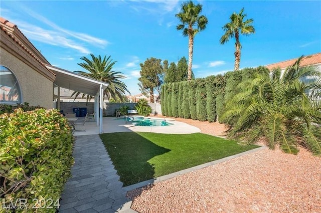 view of yard featuring a patio and a fenced in pool