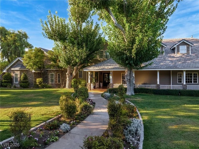 view of front facade with covered porch and a front lawn