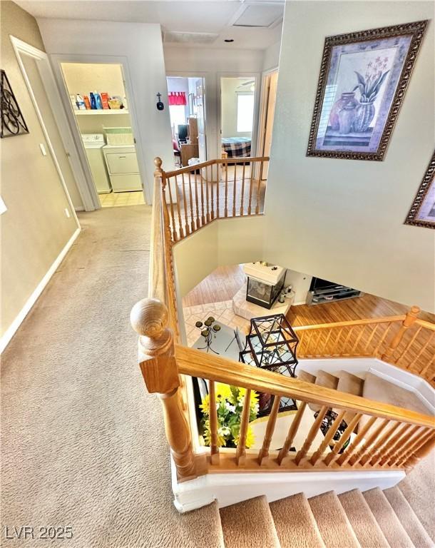 stairway featuring carpet floors, baseboards, and independent washer and dryer