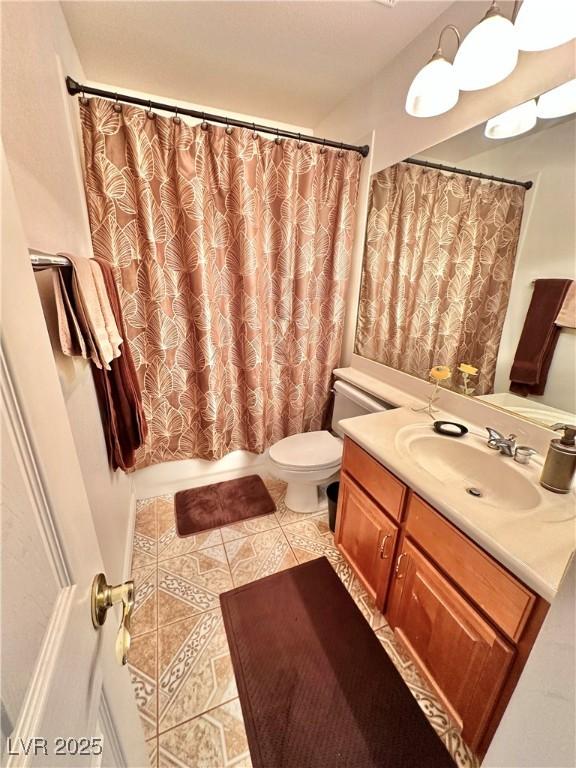 bathroom featuring toilet, vanity, and tile patterned floors