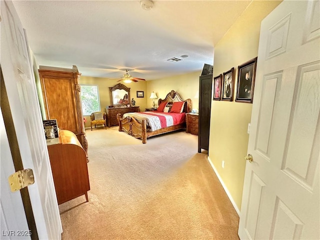 bedroom featuring light carpet, ceiling fan, visible vents, and baseboards