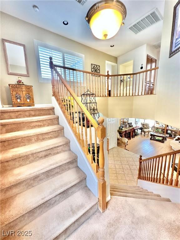 staircase featuring visible vents