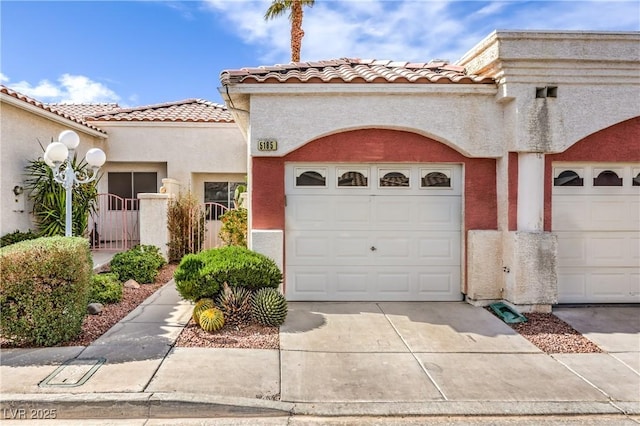 view of front facade with a garage, concrete driveway, a tiled roof, and stucco siding