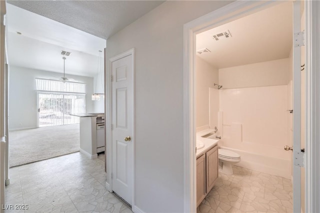 bathroom with toilet, visible vents,  shower combination, and vanity