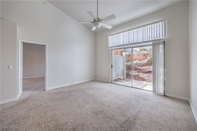 carpeted spare room featuring high vaulted ceiling, baseboards, and a ceiling fan