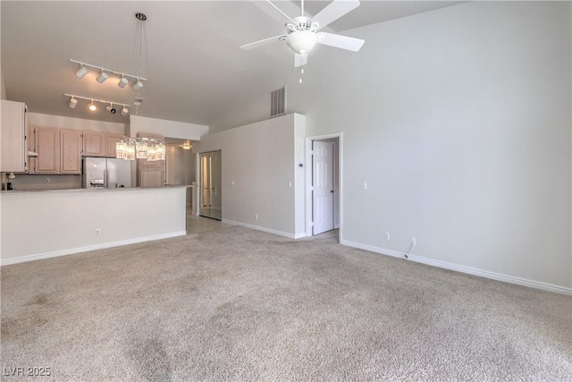 unfurnished living room with light colored carpet, visible vents, ceiling fan, high vaulted ceiling, and baseboards