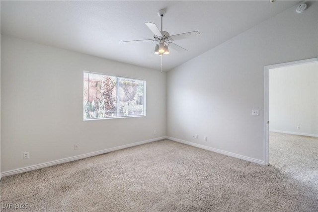 unfurnished room with light carpet, vaulted ceiling, a ceiling fan, and baseboards