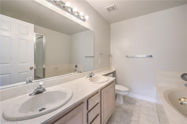 bathroom featuring a garden tub, visible vents, and a sink