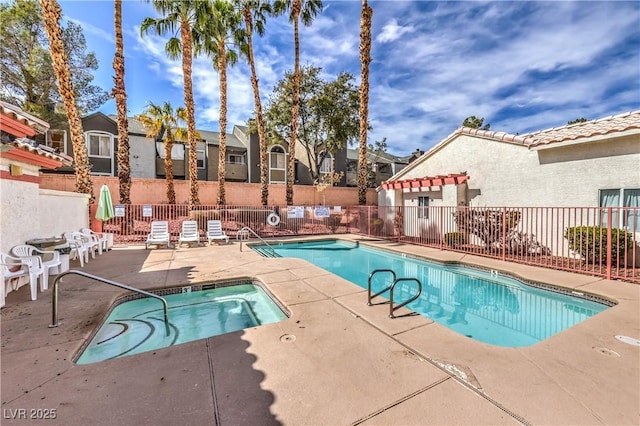 pool featuring fence and a patio