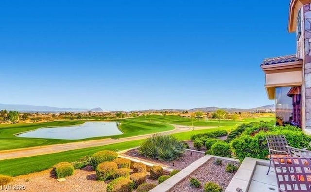 view of home's community featuring view of golf course, a patio area, and a water and mountain view