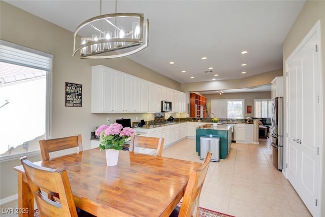 dining room with recessed lighting, a notable chandelier, and light tile patterned floors