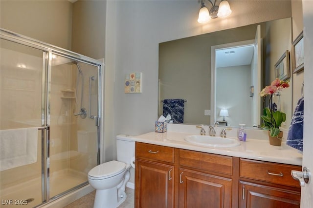 full bath featuring a stall shower, tile patterned flooring, vanity, and toilet