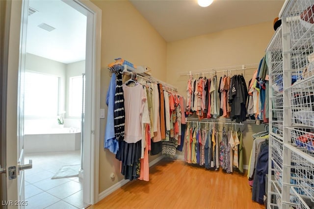 walk in closet with visible vents and wood finished floors