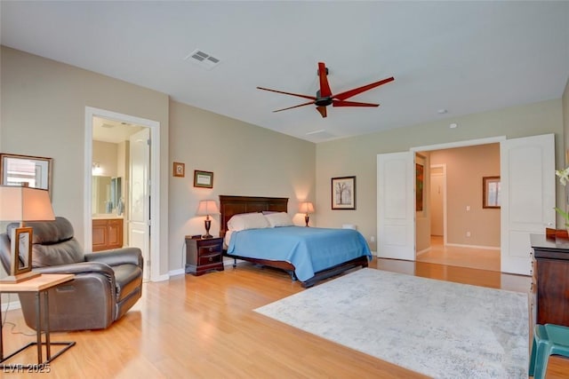 bedroom with a ceiling fan, light wood-type flooring, visible vents, and baseboards