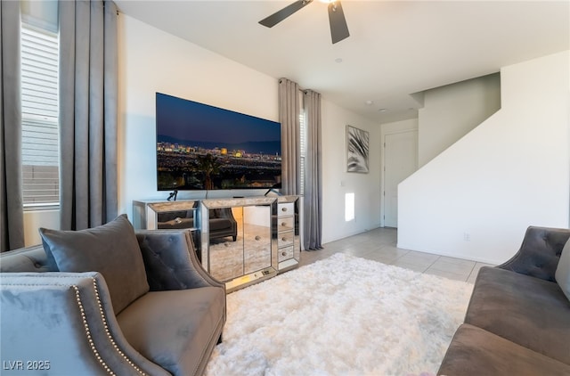 tiled living room featuring ceiling fan