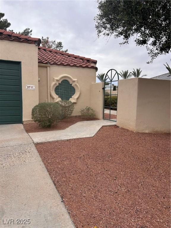 exterior space with a gate and an attached garage