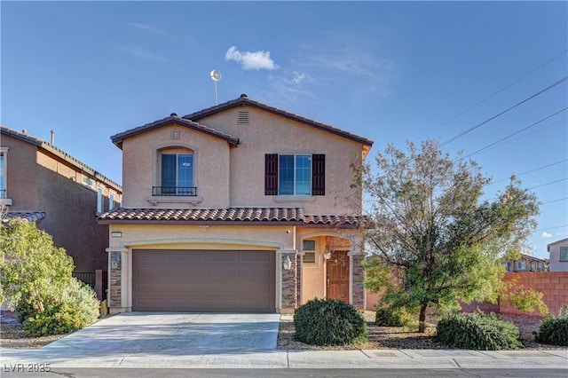 mediterranean / spanish-style home with a garage