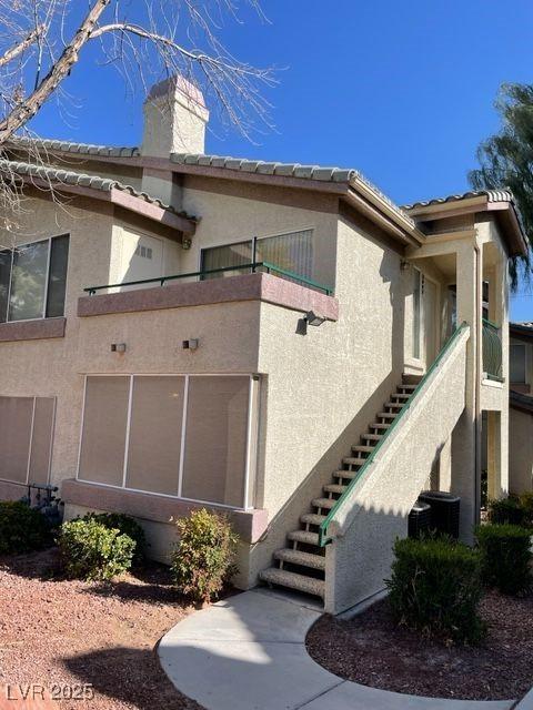 5710 E Tropicana Ave Unit 2047, Las Vegas, NV 89122 - view of side of home featuring central AC and a balcony