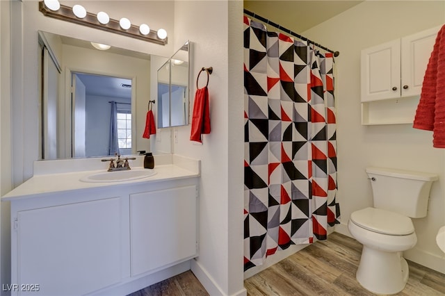 bathroom featuring hardwood / wood-style flooring, vanity, and toilet