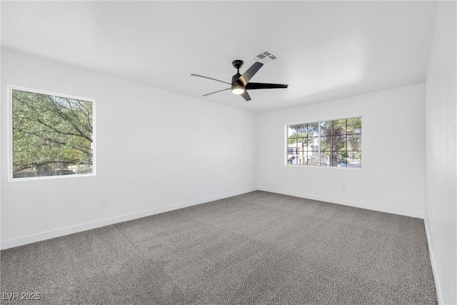 carpeted spare room with ceiling fan