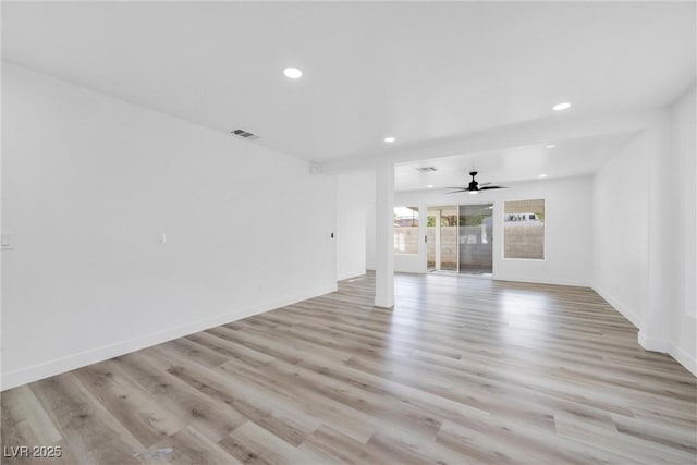 unfurnished living room featuring ceiling fan and light wood-type flooring