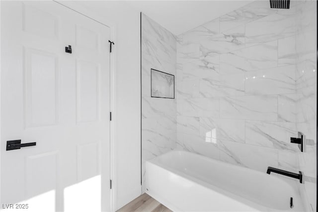 bathroom featuring tiled shower / bath and hardwood / wood-style floors