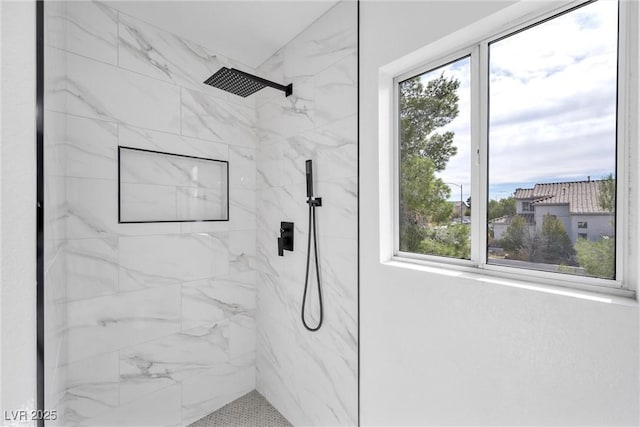 bathroom with a tile shower