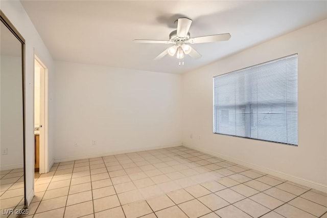 tiled empty room with ceiling fan