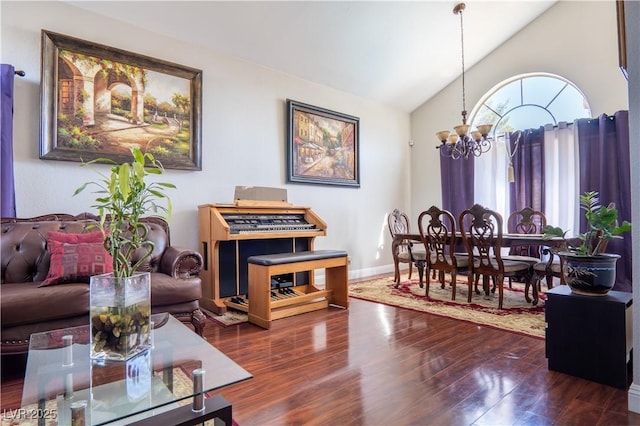 living room with lofted ceiling, an inviting chandelier, and dark hardwood / wood-style flooring