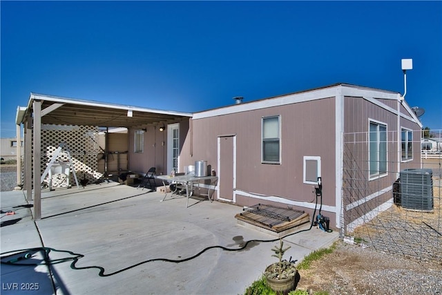 rear view of house with a patio and central AC unit