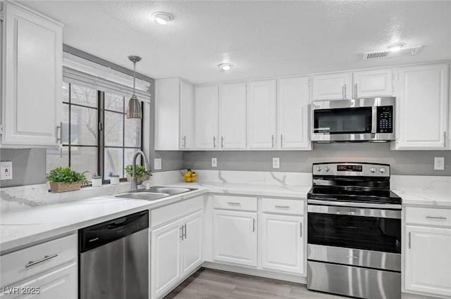 kitchen with white cabinets, stainless steel appliances, and sink