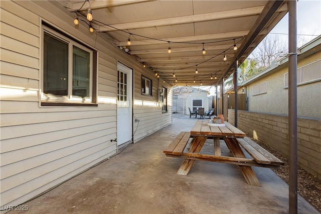 view of patio featuring a storage unit