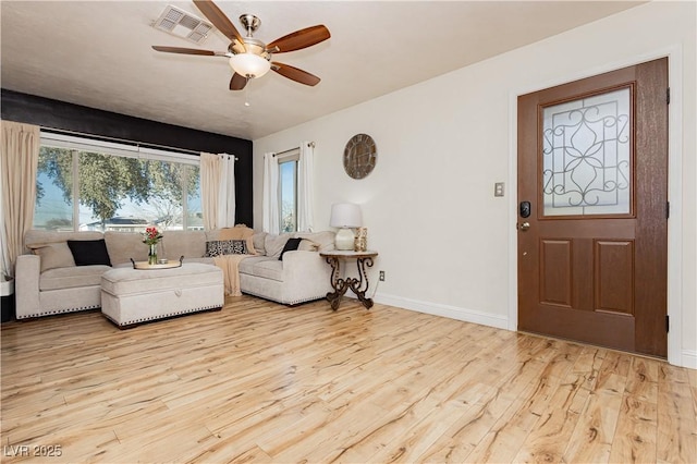 living room with light wood-type flooring and ceiling fan