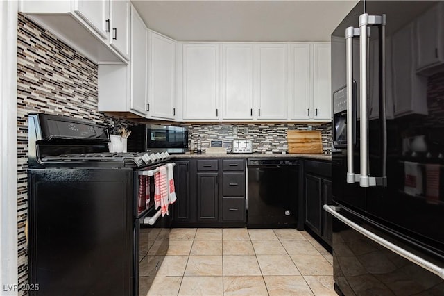 kitchen with white cabinetry, black appliances, light tile patterned floors, and decorative backsplash