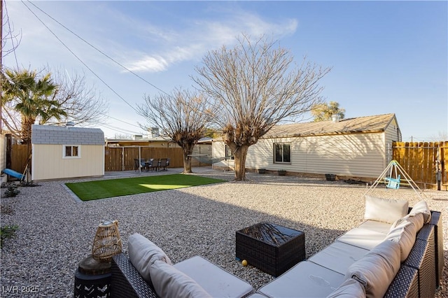 view of yard featuring a shed, an outdoor hangout area, and a patio area