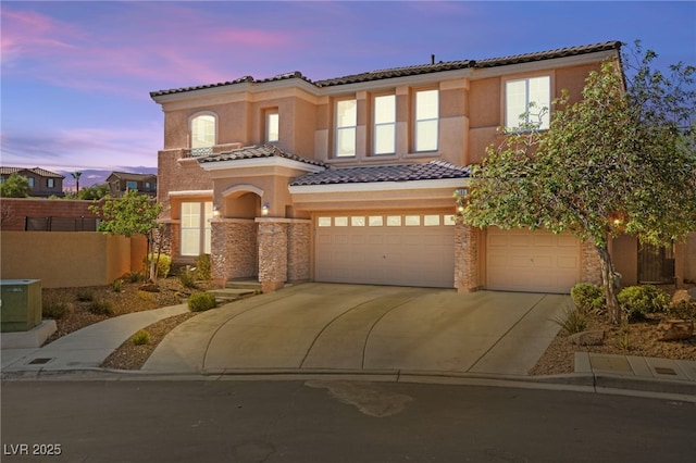 mediterranean / spanish-style house with a garage