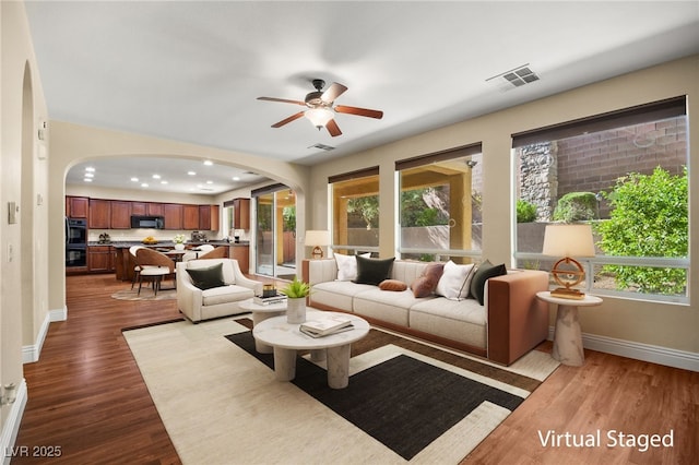 living room with ceiling fan and light hardwood / wood-style floors