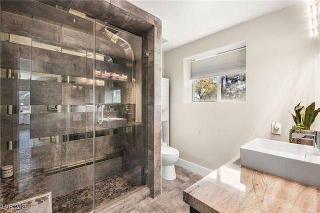 bathroom featuring sink, an enclosed shower, and toilet