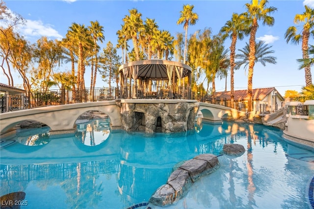 view of swimming pool with a gazebo and a water slide