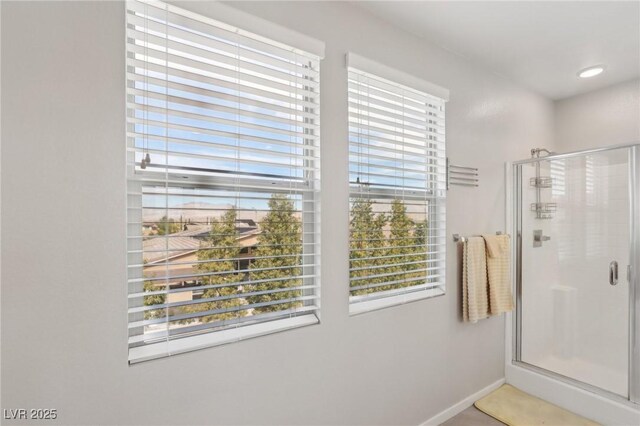 9690 Hiking Ave, Las Vegas, NV 89166 - bathroom featuring a shower stall, baseboards, and a wealth of natural light